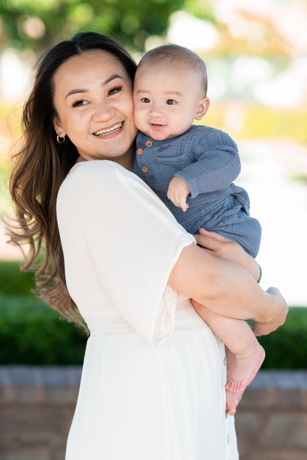 Mother smiling while holding her baby son
