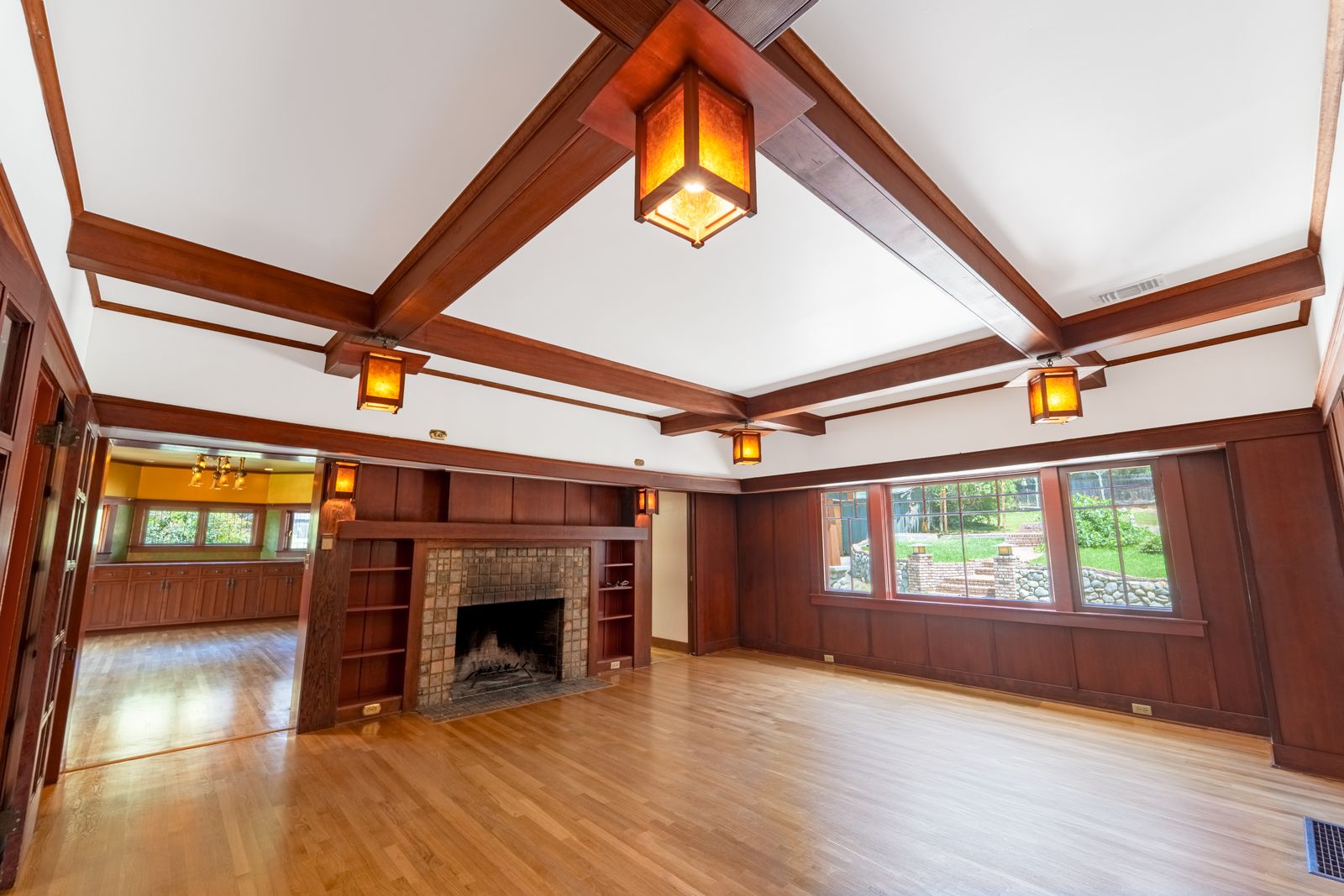 Living room with a beamed ceiling, lantern lights and a brick fireplace