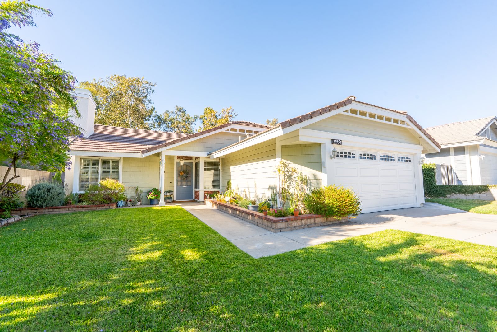 Single-story home with a two-car garage and green lawn