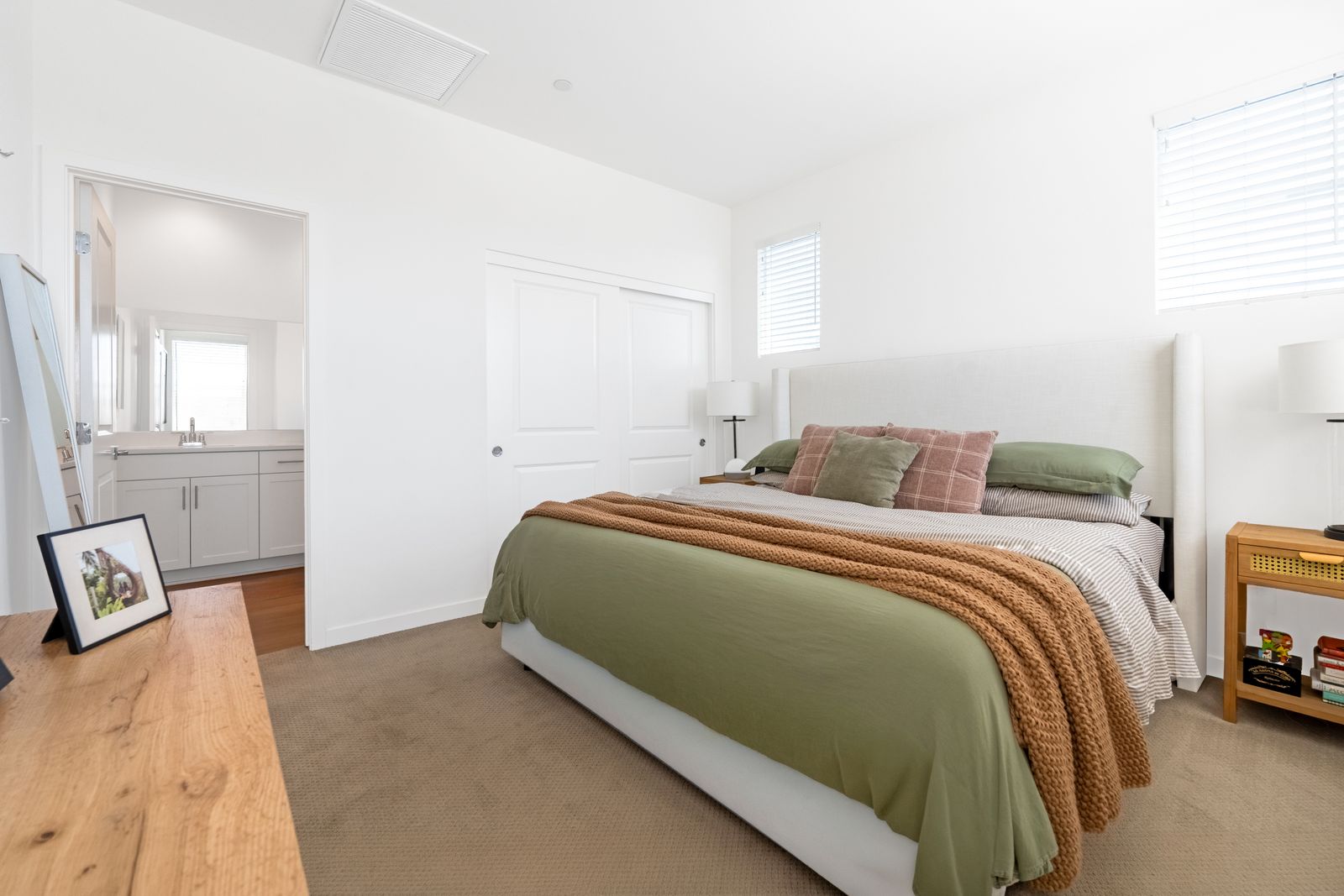 Bedroom with green bedding and natural light