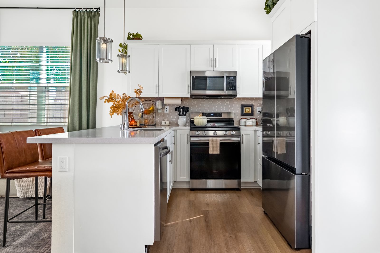 White kitchen with stainless appliances and a breakfast bar